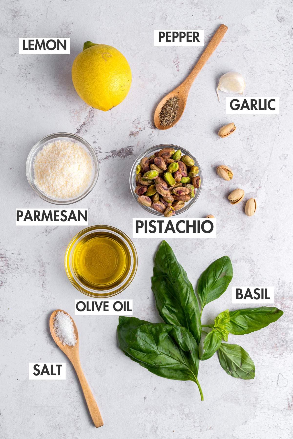 Ingredients for pistachio pesto on a marble board.