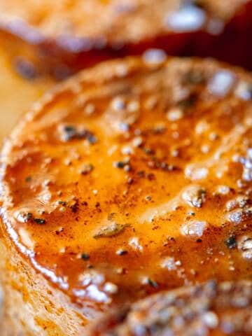 Close up of cooked potato fondants in stainless steel pan.