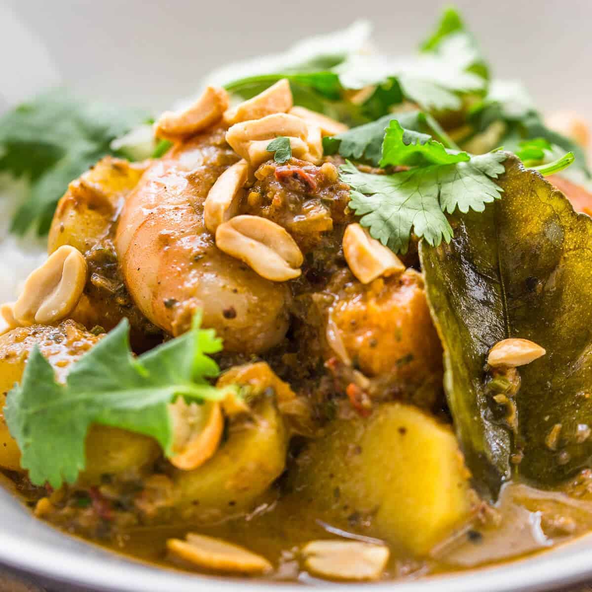 prawn massaman curry closeup in white bowl.