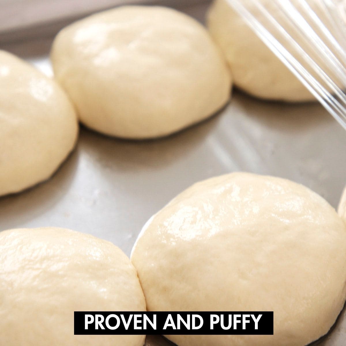 Proven naan balls on a tray.