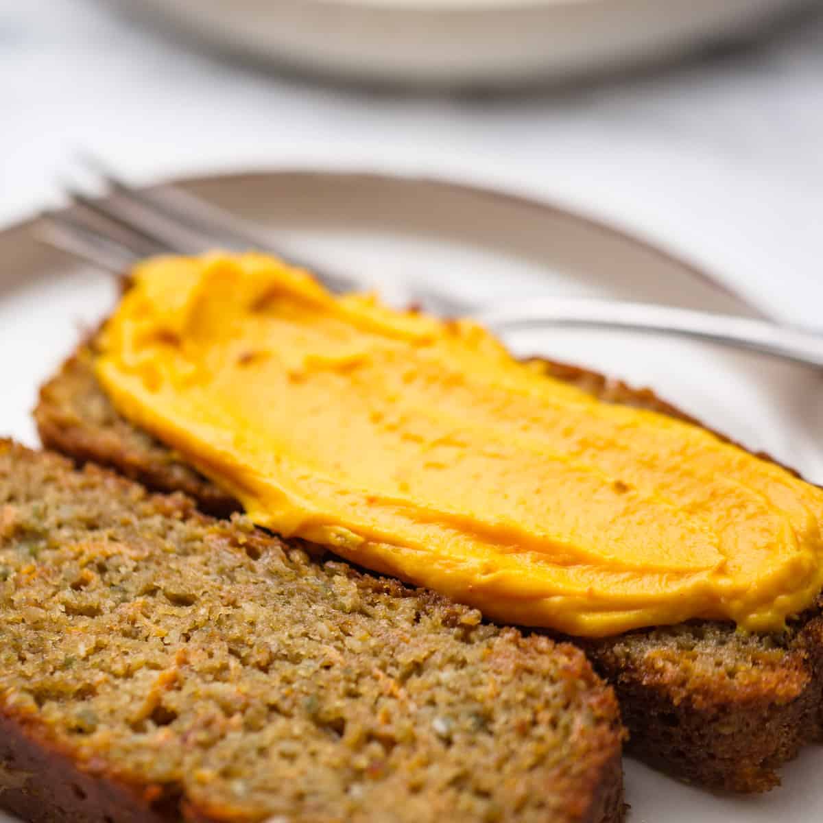 Pumpkin cake on plate with pumpkin spread.