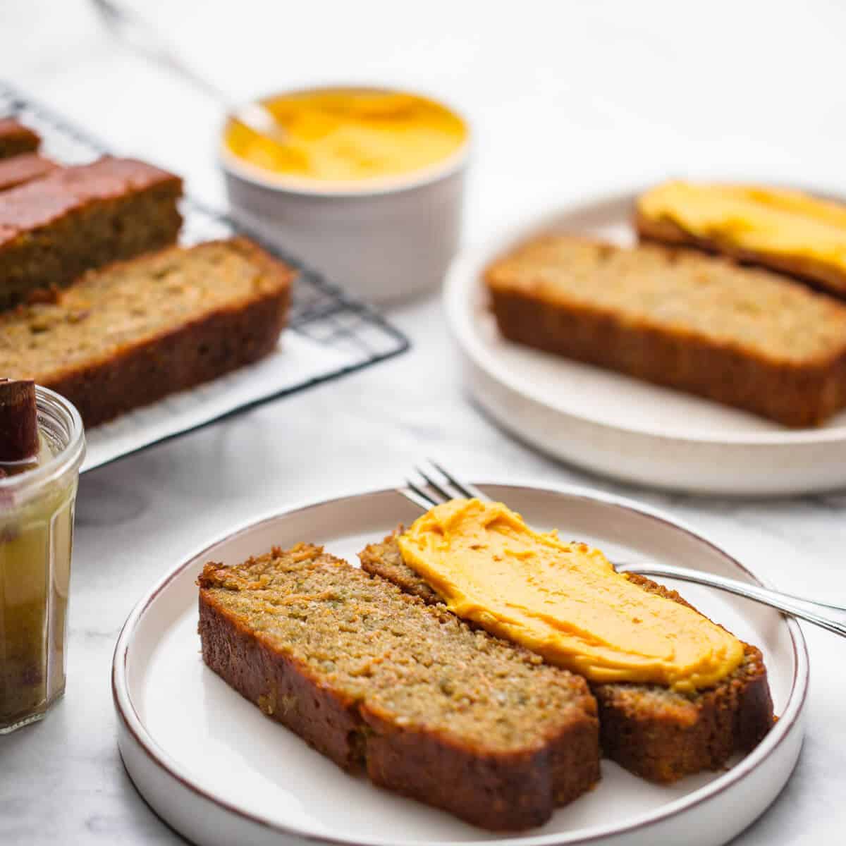 Pumpkin cake on various plates with pumpkin spread.