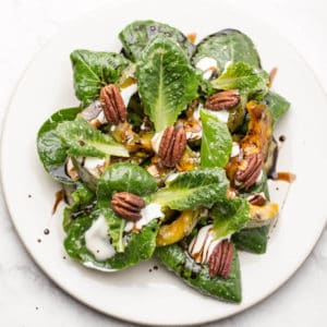 roasted pumpkin salad on white plate.