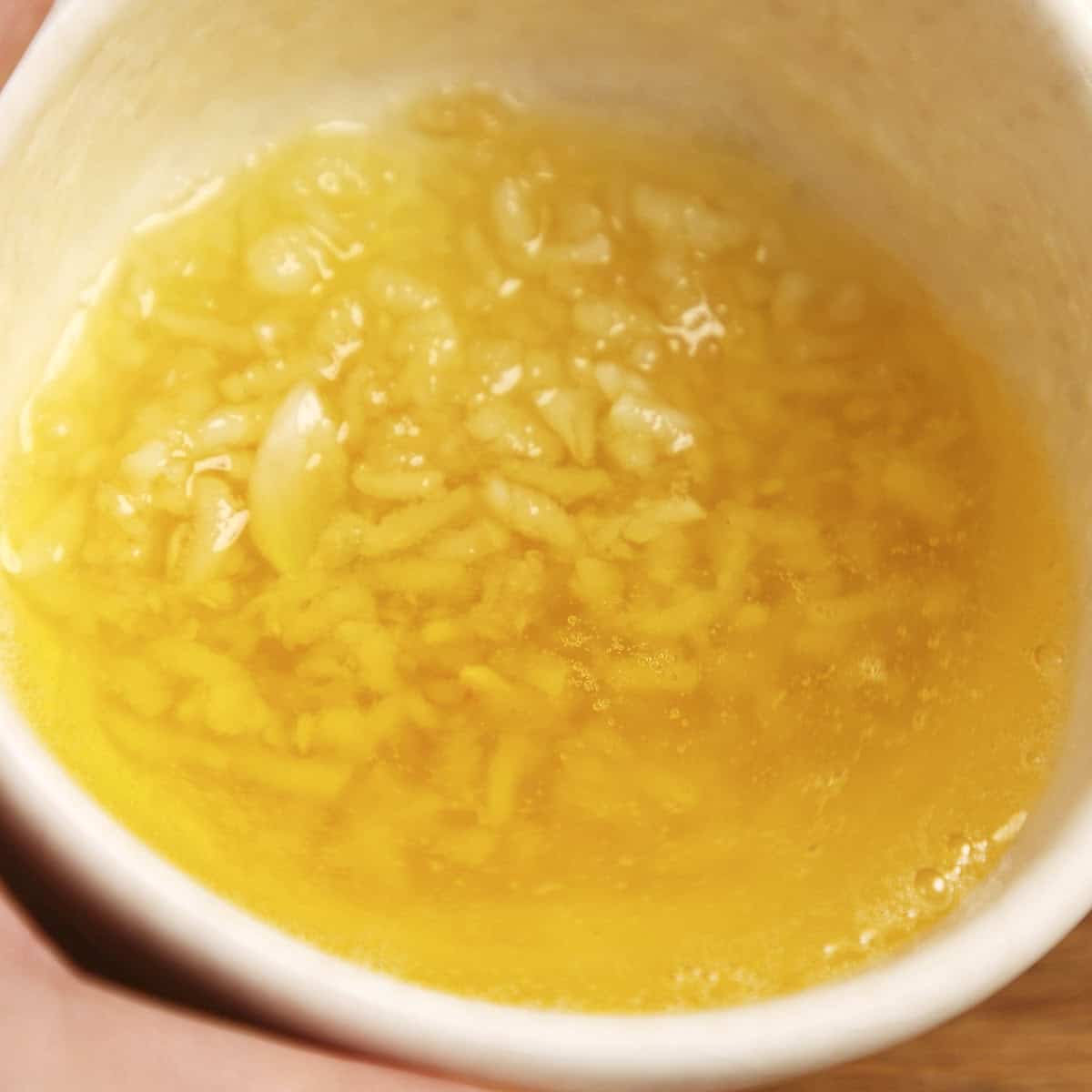 Garlic butter in a white bowl.