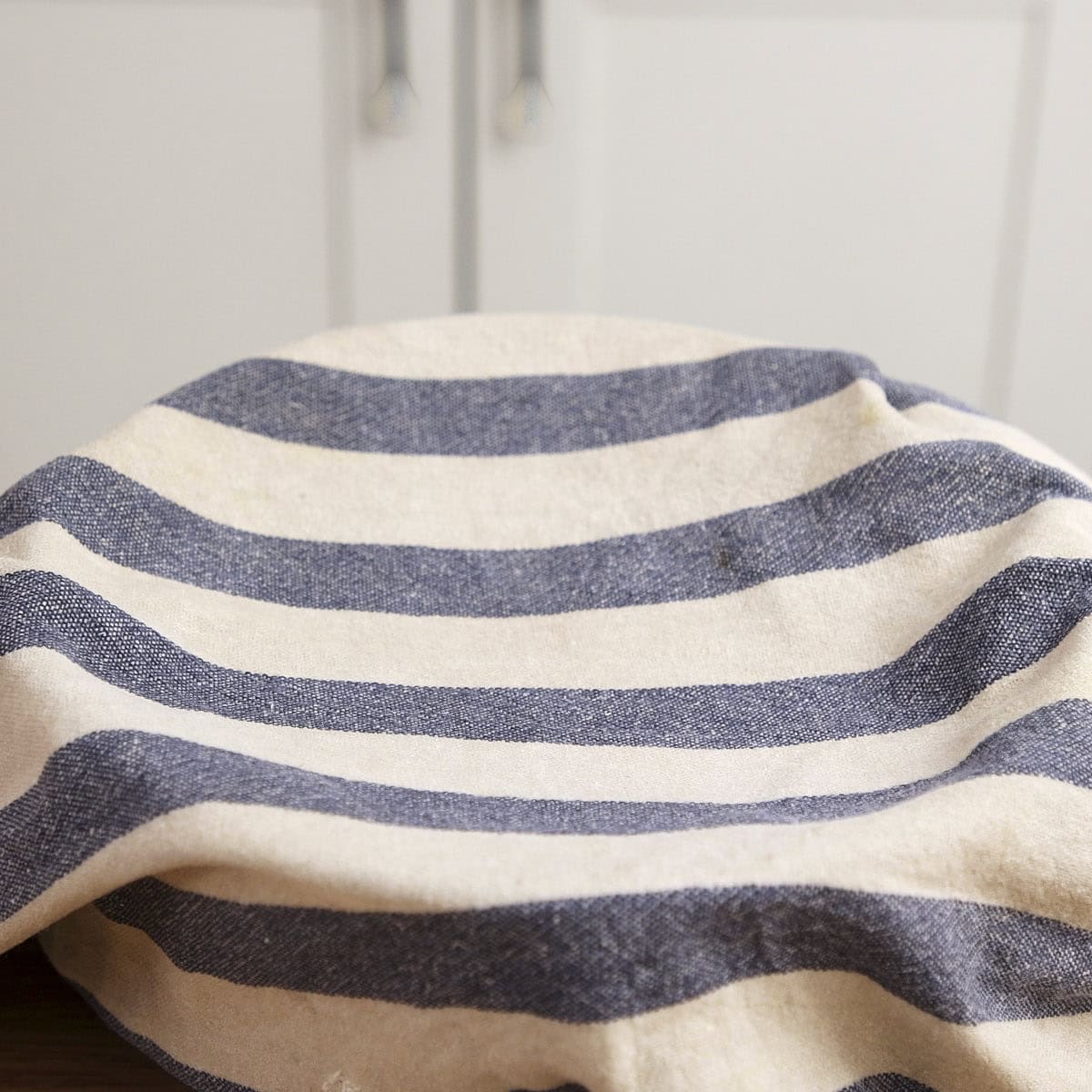 Damp cloth covering a bowl.