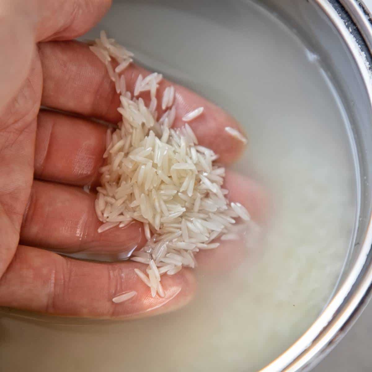Washing rice in water.