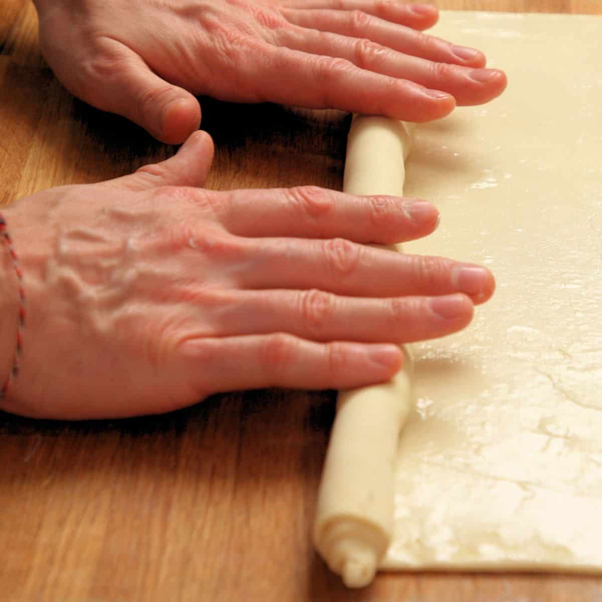 Rolling pastry into a log.