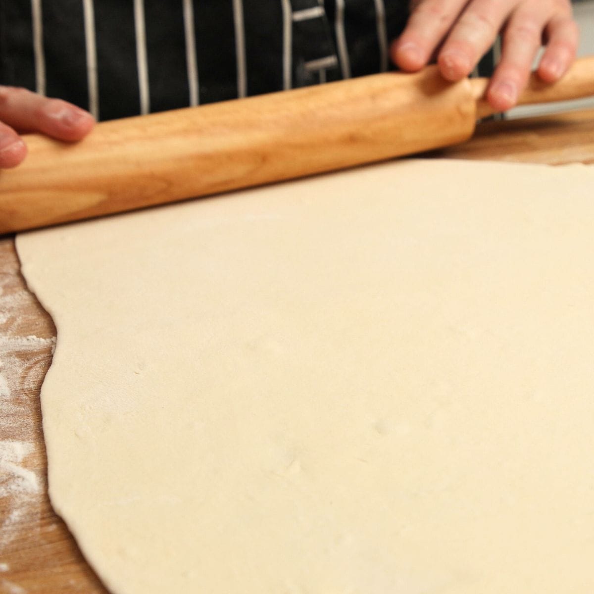 Rolling dough out on a table.