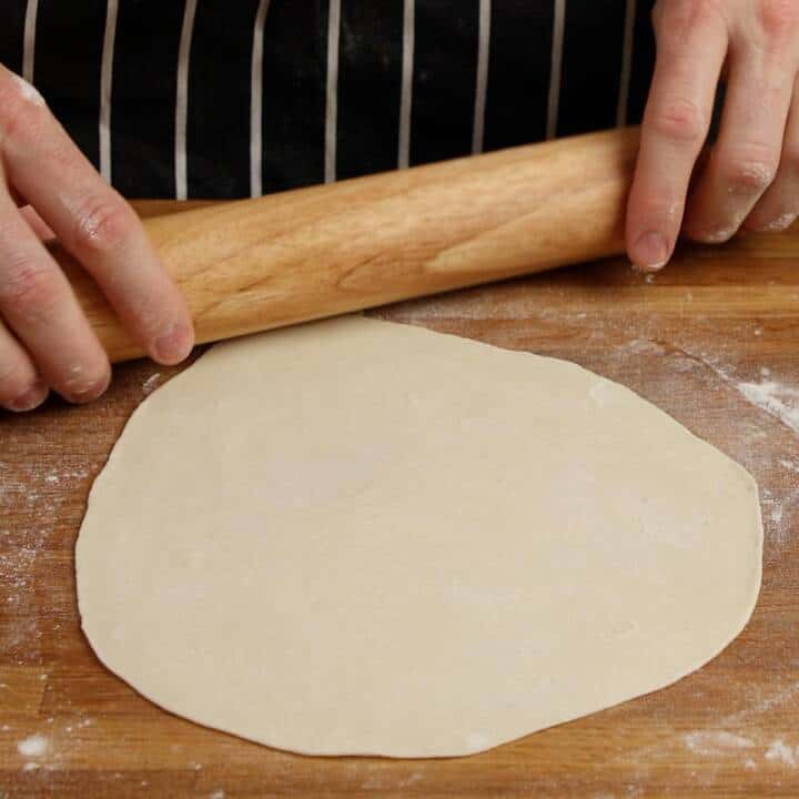 Rolling out flatbread dough.