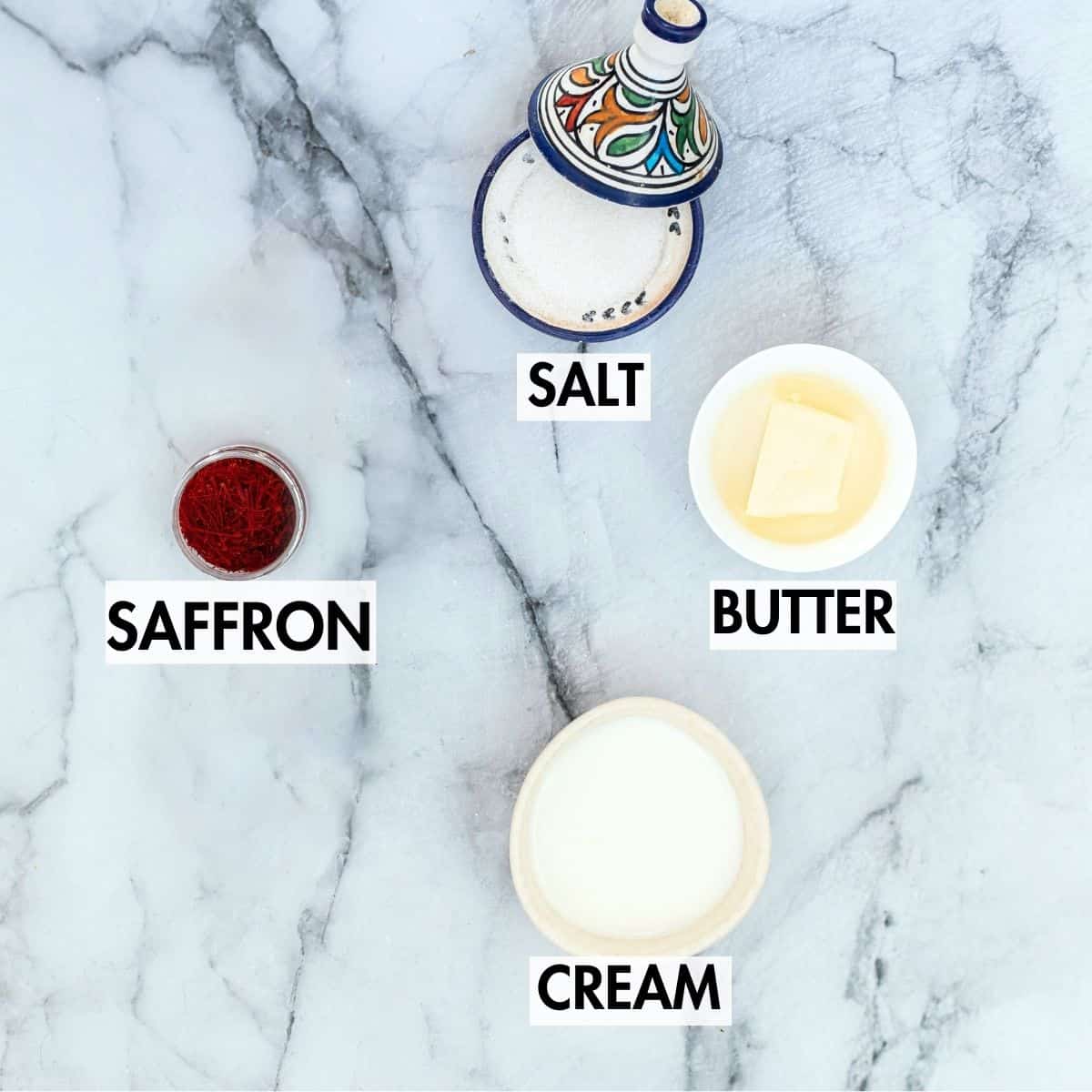 Ingredients for making saffron sauce on a marble surface.