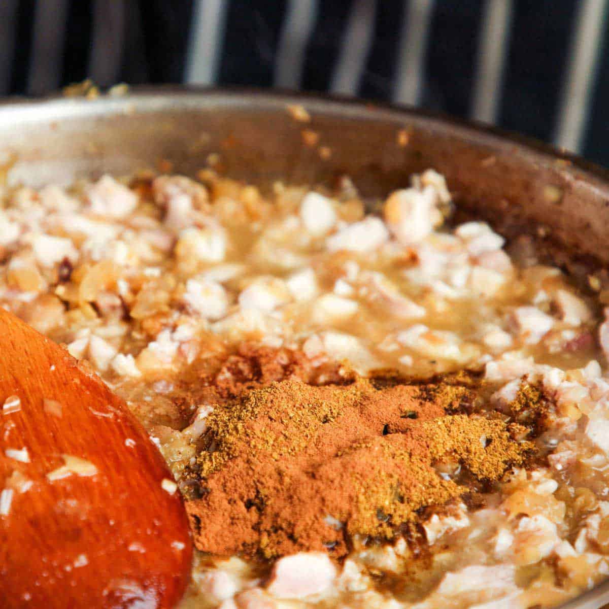 Onions and spices in a pan.