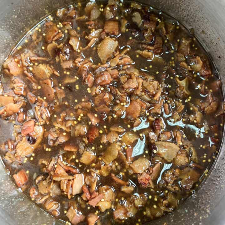 Bacon jam simmering in a sauce pan.