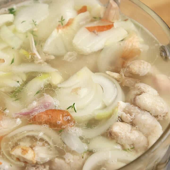 Ready to strain chicken stock in a pot.