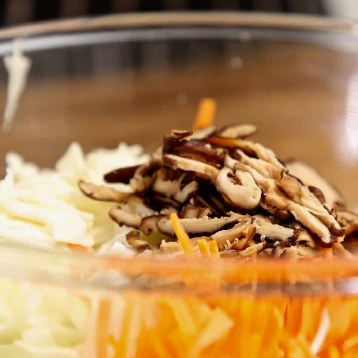 Shredded vegetables in a glass bowl.
