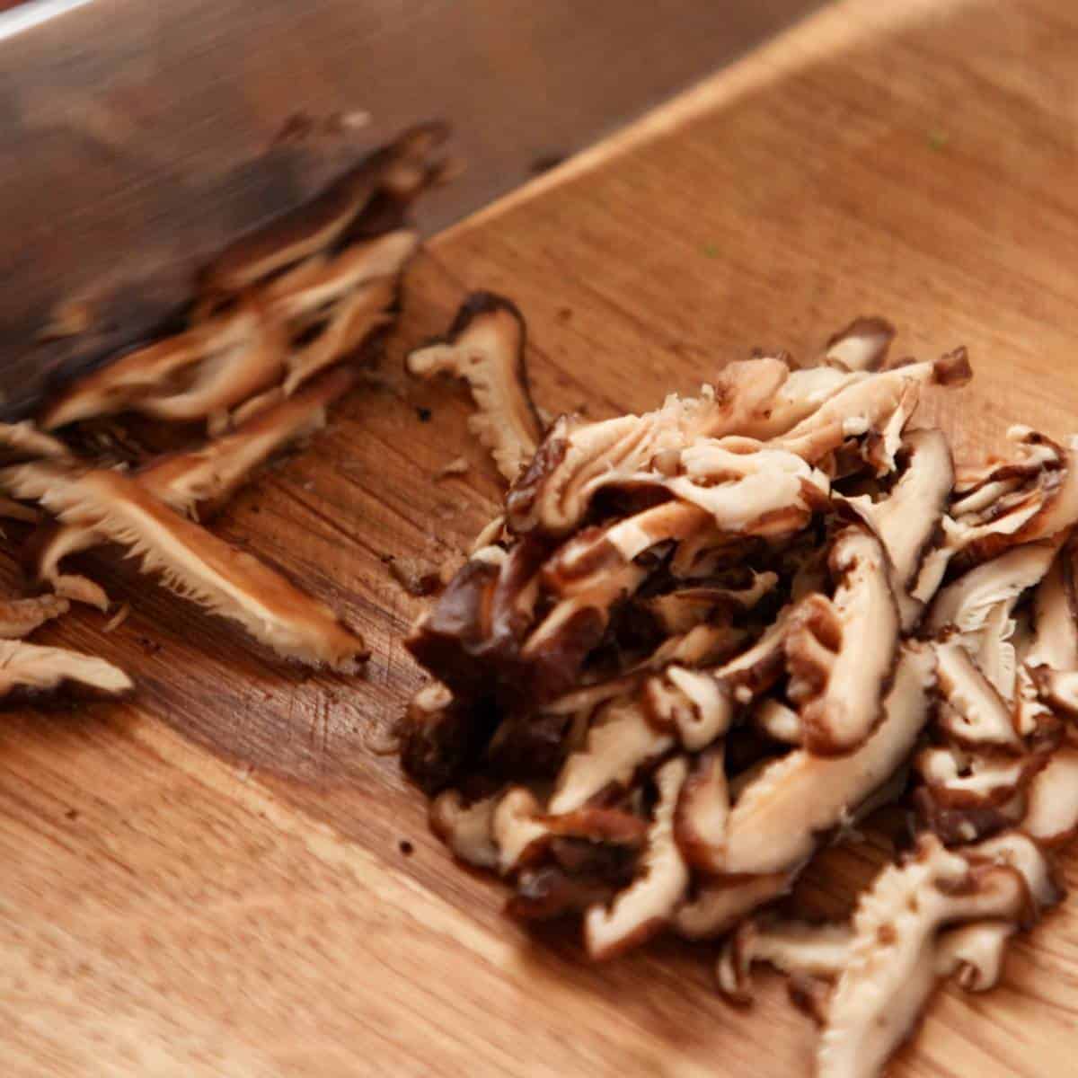 Slicing shiitake mushrooms.