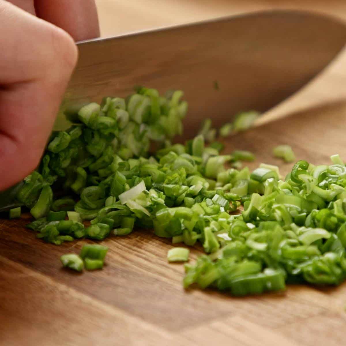 Chopping scallions.