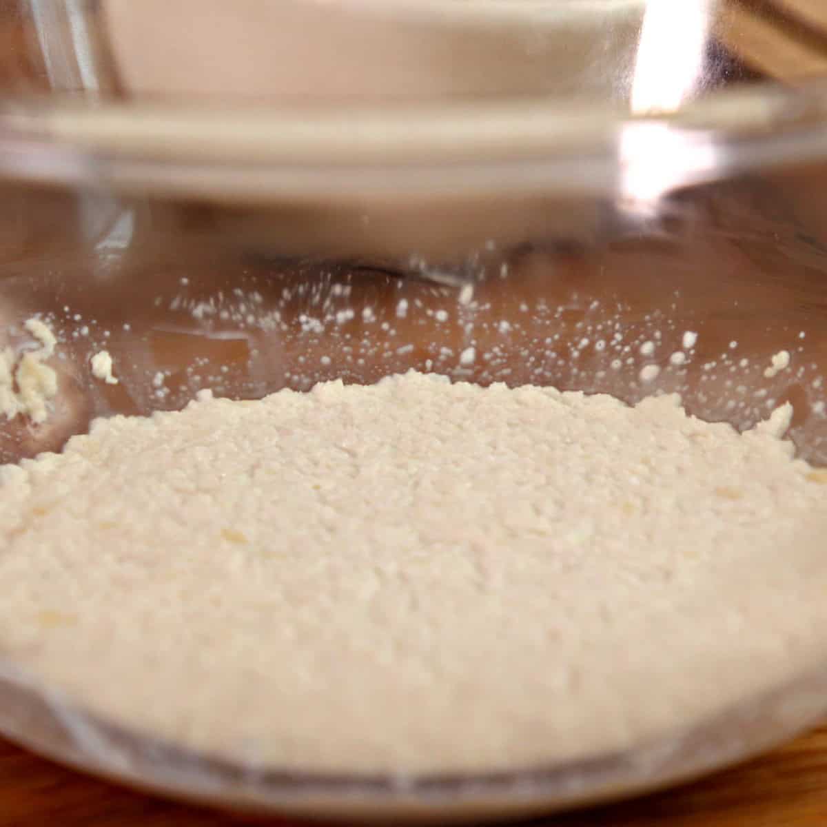 Soaked breadcrumbs in a glass bowl.