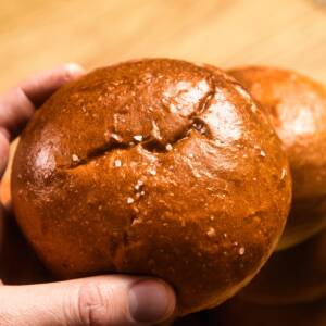 Burger bun on wooden background.