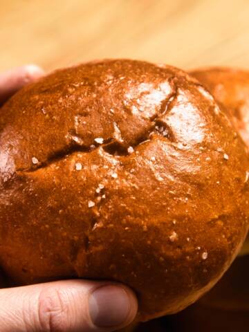 Burger bun on wooden background.