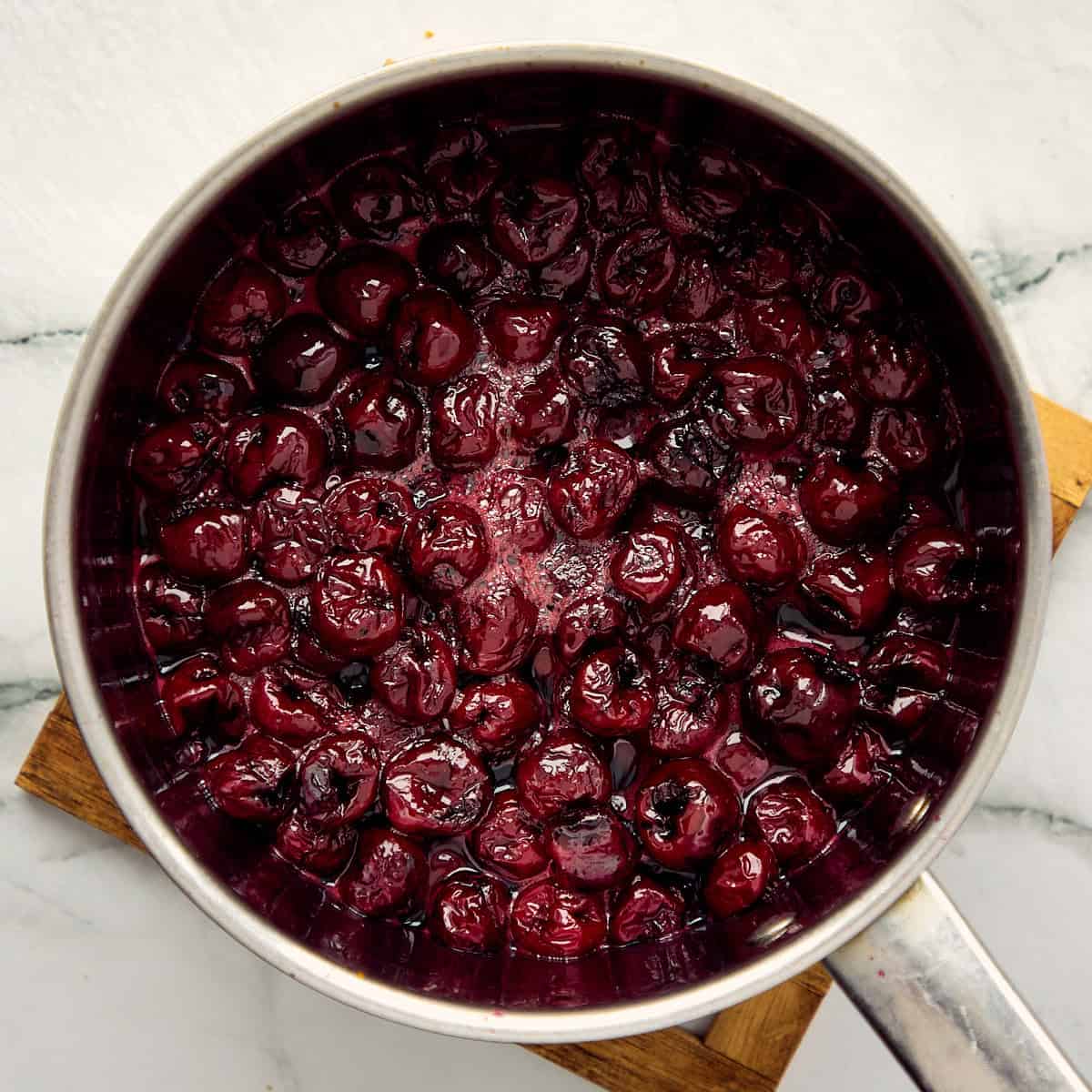 Cherries boiling in a pot.