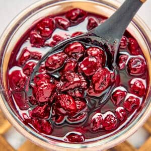 Sour cherry jam in a glass jar.