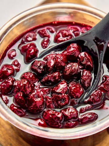 Sour cherry jam in a glass jar.