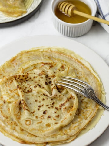 Sourdough discard crêpes on a white plate.