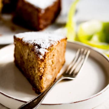 slice of spiced apple cake on a plate with vintage fork