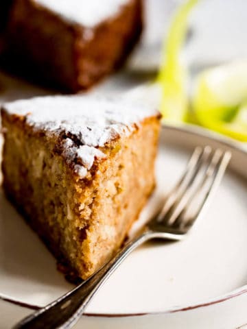 slice of spiced apple cake on a plate with vintage fork