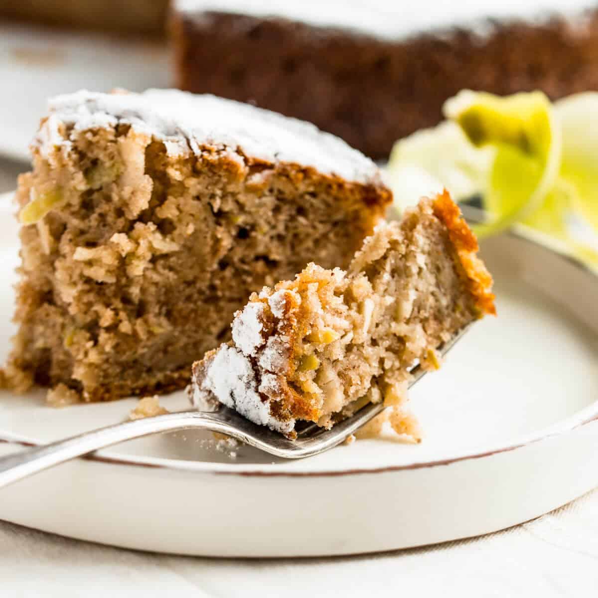 slice of spiced apple cake on a plate with vintage fork