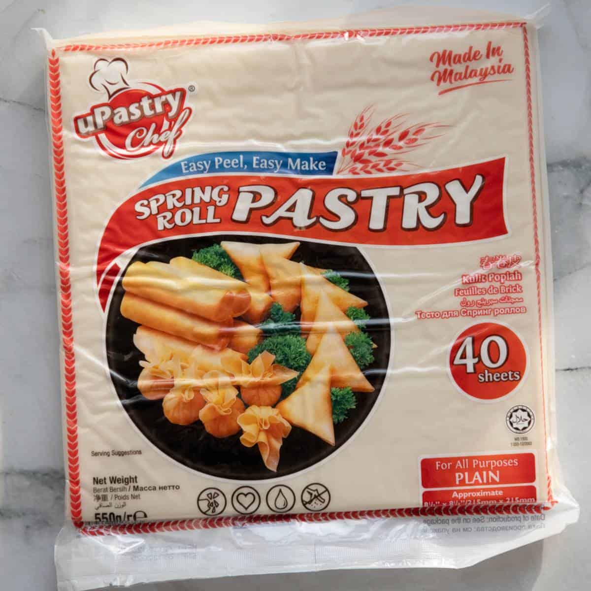 Store-bought spring roll pastry on a marble surface.