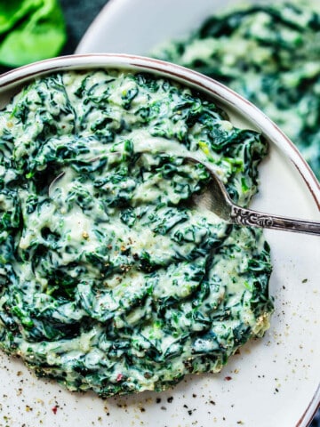 creamed spinach on a white plate.