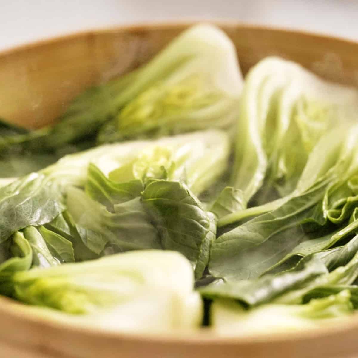 Bok choi in steamer basket.