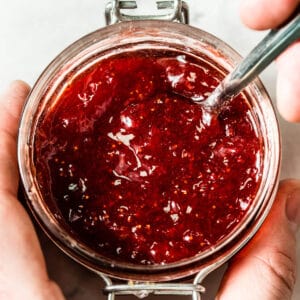 red strawberry jam in clear glass jar viewed from the top