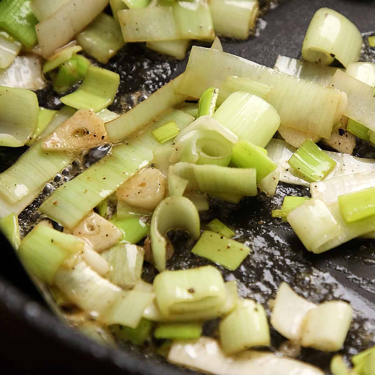 Sweating down leeks and garlic in a pan.