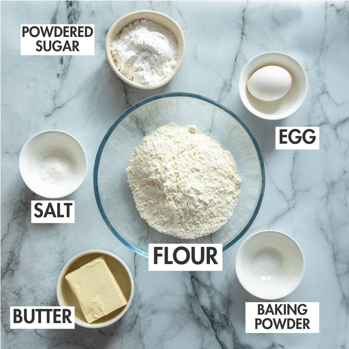 Ingredients for making milk tart crust on a marble board.