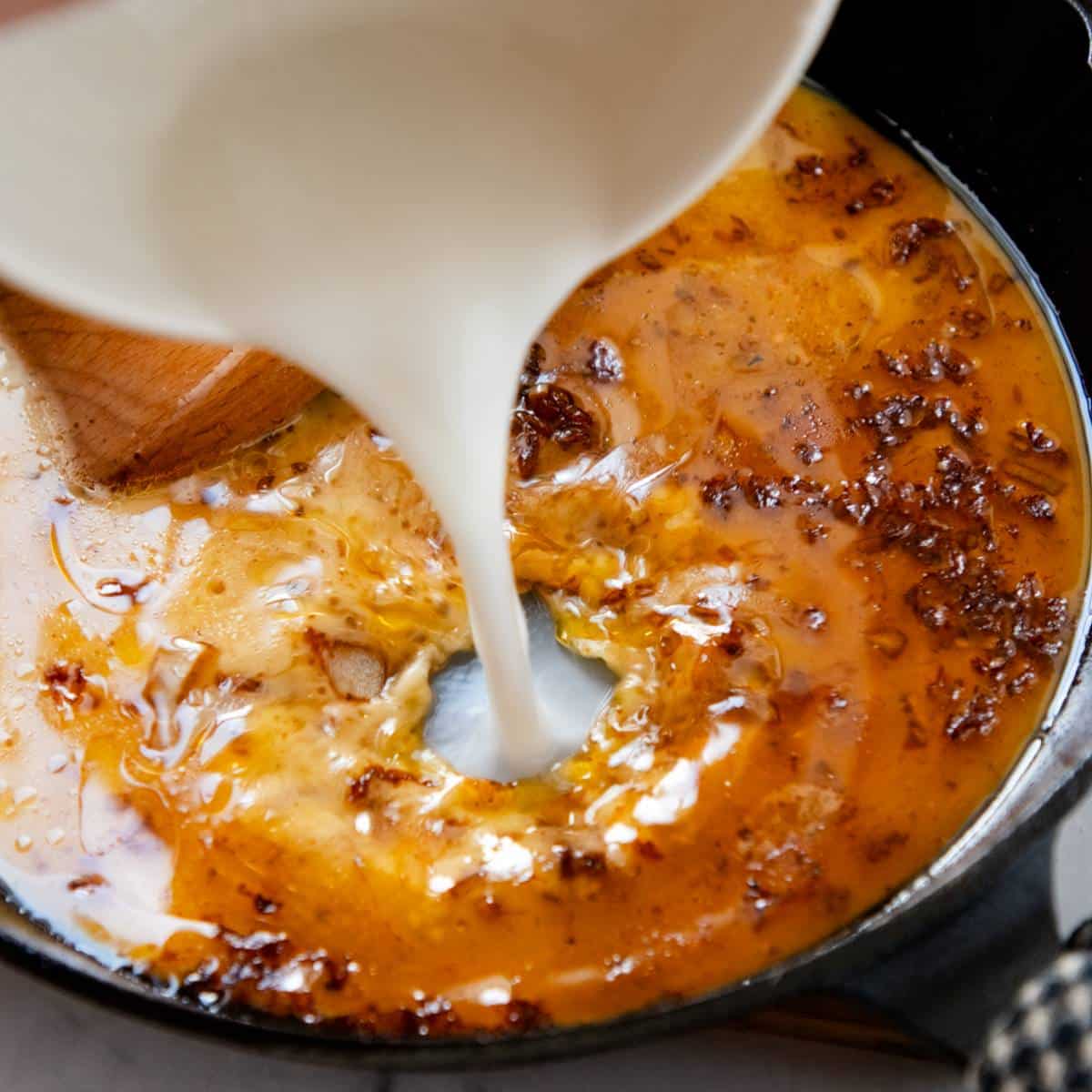 Thickening gravy in a pan with a cornstarch slurry.