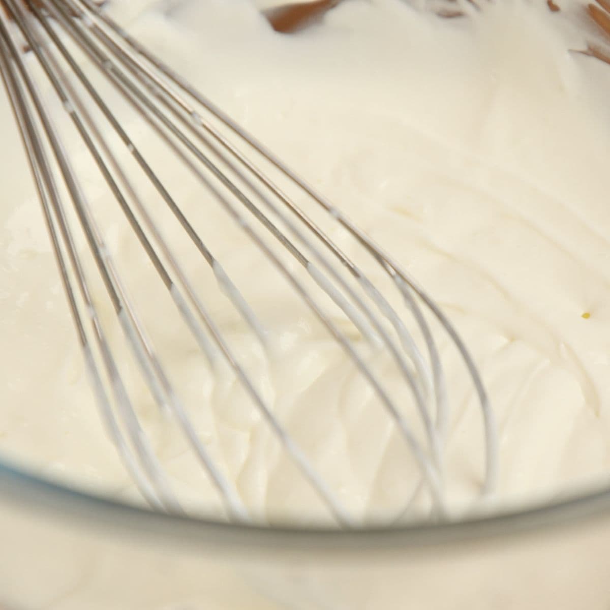 Whisking yogurt in a bowl.