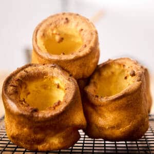Yorkshire puddings on a wire rack.