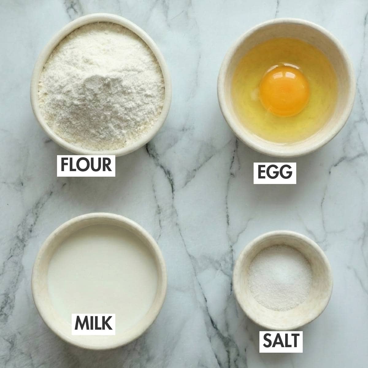 Ingredients for making Yorkshire pudding on a marbled slab.